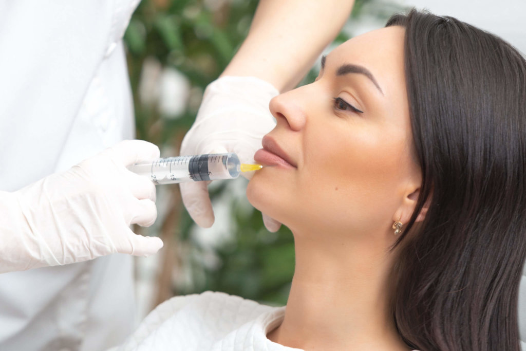 Young Female Getting Injection on Lips | Gig Harbor Aesthetics in Gig Harbor, WA