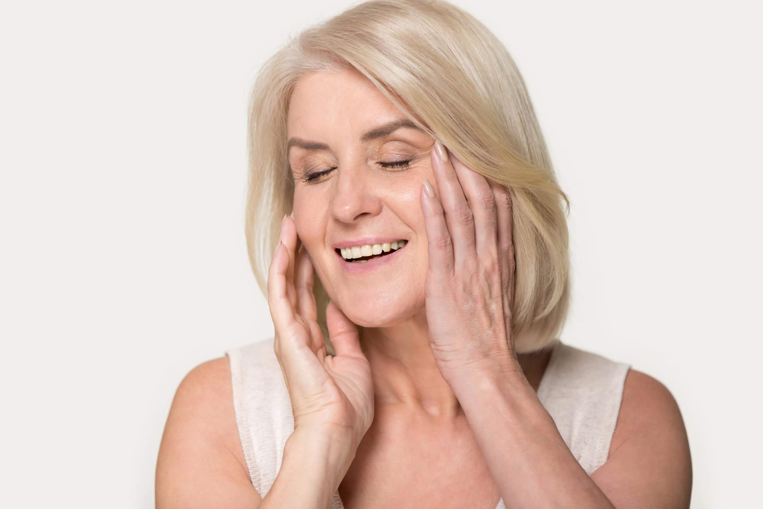 Smiling Lady Touching her Face | Gig Harbor Aesthetics in Gig Harbor, WA