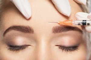 Young Female Getting Botox Injection on Forehead | Gig Harbor Aesthetics in Gig Harbor, WA